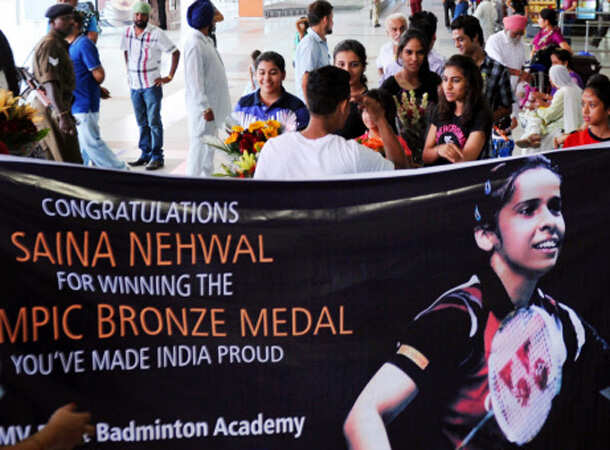 Champion Saina returns home 