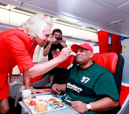Richard Branson dresses up as AirAsia flight attendant